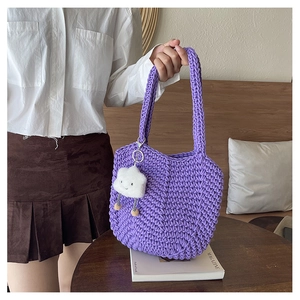 Close-up of handmade purple woven tote bag featuring a cute white cloud plush pendant charm