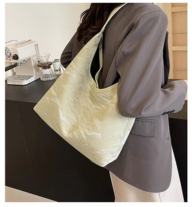 Lifestyle view of a large light green hobo bag with marble texture on a model