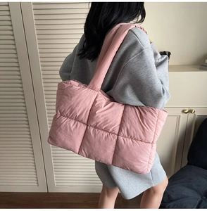Pink quilted tote bag shown on shoulder in a minimalist indoor setting for daily style