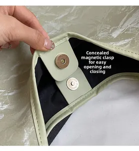 Close-up of the hidden magnetic closure and inner lining on a green tote bag