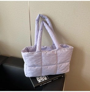 Light purple quilted tote bag detail with square puffy texture and matching wide strap