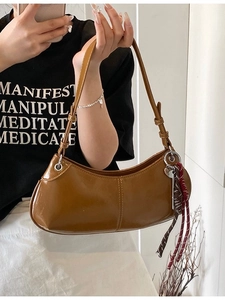 Chic brown caramel hobo shoulder bag in glossy faux leather with woven knot detail