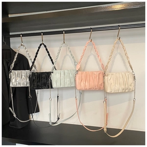 Detailed display of ruched crossbody bags in silver, black, green, pink and beige tones
