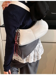 Chic white glossy PU leather underarm dumpling bag with dual-tone knotted charm detail