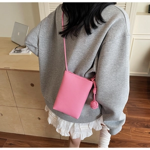 Pink lychee texture mini crossbody phone bag with knot detail and slim shoulder strap