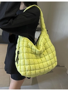 Lime green quilted puffer tote bag with a crescent shape and padded shoulder strap