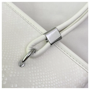 Detail of white snake-pattern tote bag showing silver metal buckles and neat stitching