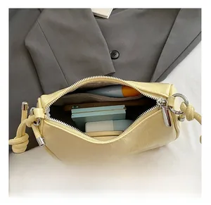 Top view of yellow leather dumpling bag interior storage capacity for phone and cosmetics