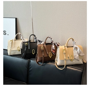 Detail of woven texture handbags with silk scarves and golden oval locks in four colors