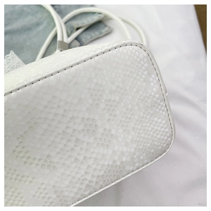 Close-up of white animal skin pattern embossing on high-quality faux leather tote bag