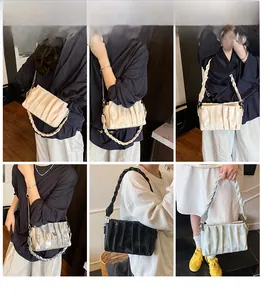 Detail view of ruched pleated handbag featuring chain strap in four assorted colors