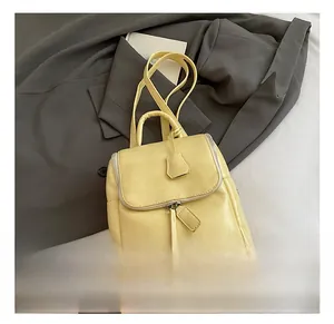 Detail showing the light yellow PU leather backpack with top flap and zipper closure