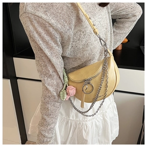 Close-up of saddle bag with chunky silver chain and Le Breeze embossed lettering