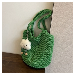Detailed honeycomb knit texture of the bright green woven tote bag with a cloud charm
