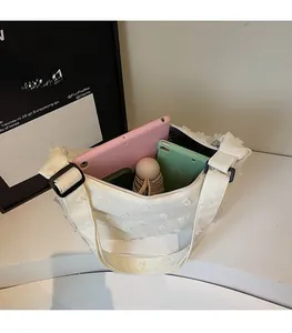 Top view of spacious cream canvas tote interior holding tablets and folding umbrella