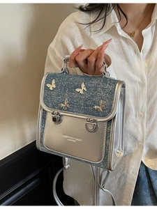 Blue denim and silver leather crossbody bag with metal butterfly accents for women