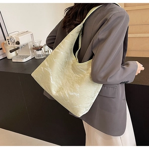 Detail of light green oversized tote bag with marble texture finish in cafe setting