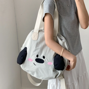 Close-up of cute cartoon dog embroidery and soft nylon texture on large shoulder bag