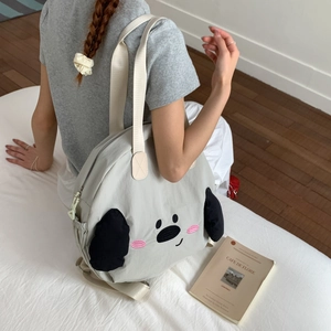 Close-up of light grey nylon tote bag with puppy embroidery and 3D ear detail