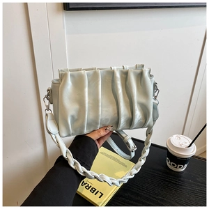 Detail of light blue pleated cloud bag featuring silver hardware and dual straps