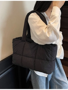 Black quilted down tote bag with spacious interior for versatile casual commuting