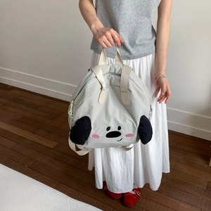 Detail view of cute grey nylon backpack with cartoon face embroidery and 3D ears