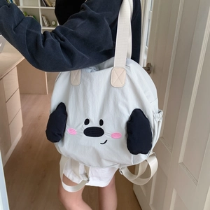 Detail of cute beige nylon tote bag featuring puppy embroidery and 3D plush ears