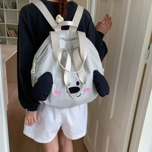Detail view of light grey nylon dog cartoon backpack with 3D ears and durable straps
