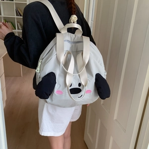 Close-up detail of cartoon dog face embroidery and 3D ears on nylon backpack