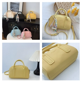 Detail of Boston bag with lychee grain texture and colorful rainbow tassel charm