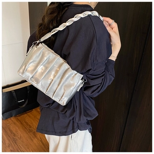 Detail of silver pleated shoulder bag featuring a chunky metallic chain strap for women