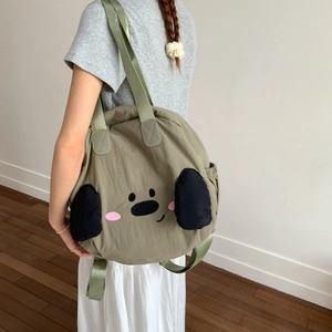 Detail of olive green nylon tote bag with 3D animal ears and adjustable straps
