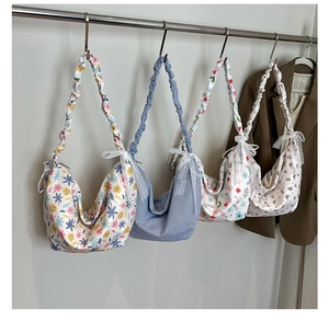 Detail of four floral oxford shoulder bags with pleated straps and lace bow accents