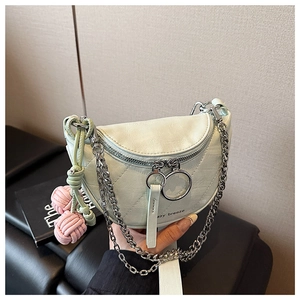 Close-up of light green quilted saddle bag with silver chain and azy breeze text