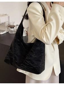 Minimalist black textured leather tote bag for women shown with a model for daily commuting