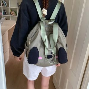 Detailed back view of grey nylon backpack featuring a cute cartoon dog face with 3D ears