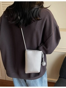 Chic silver pebbled leather mobile phone crossbody bag with stylish woven charm detail