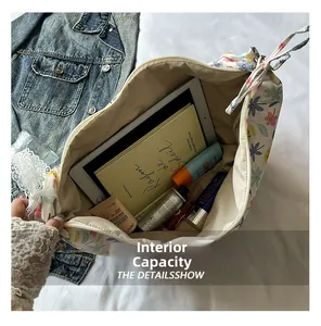Spacious interior of floral oxford cloth bag showing tablet and cosmetics storage