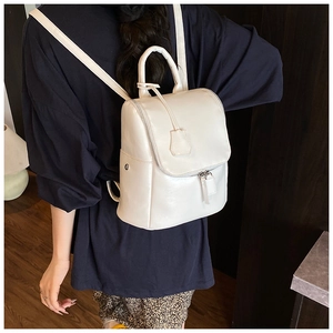Detailed back view of a white PU leather backpack featuring metal rivets and top handle