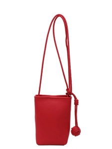 Red lychee pattern mini crossbody phone bag with knot decorative strap on white backdrop