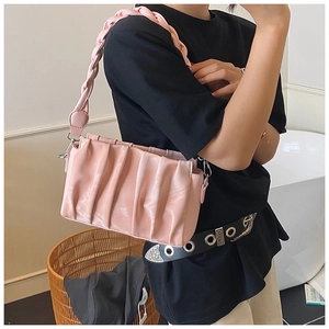 Detail of pink pleated cloud bag with thick woven shoulder strap and metal hardware