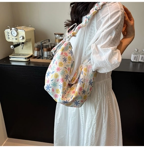 Close-up of floral Oxford cloth bag with lace trim and ruffled shoulder strap