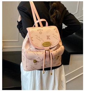Pink bucket backpack detail featuring textured synthetic leather and monogram patterns