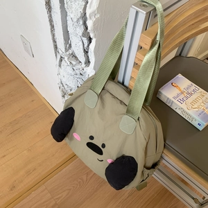 Detail view of khaki nylon tote bag with cute cartoon face embroidery and black ears