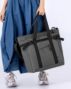 Detail of grey multi-pocket tote bag showing the textured fabric and NONGKA label