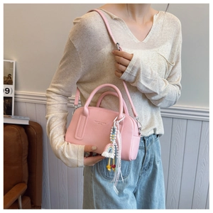 Pink Boston bag detail featuring litchi texture leather and rainbow knit charm