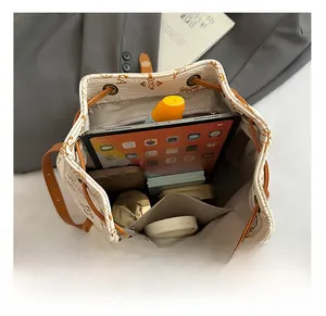 Interior view of monogram bucket bag showing large capacity for tablet and cosmetics