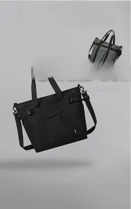 Detail of durable nylon tote bags in black and dark grey with tactical webbing and buckles