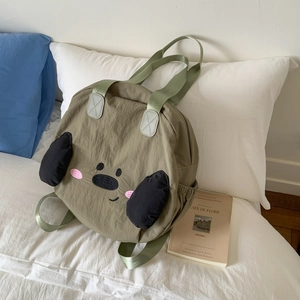 Detail view of the cute cartoon nylon tote bag showing soft texture and embroidered face