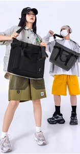 Detail view of high-capacity black and grey nylon crossbody bags with adjustable straps